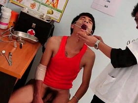 Young man undergoes rectal examination by attractive doctor