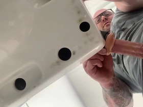 Solo guy strokes his dildo in the bathroom